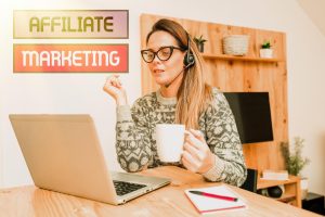 Młoda kobieta używająca telefonu kom&oacute;rkowego na stole