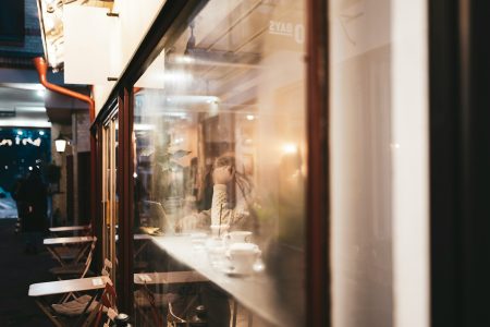 a couple of people standing outside of a building