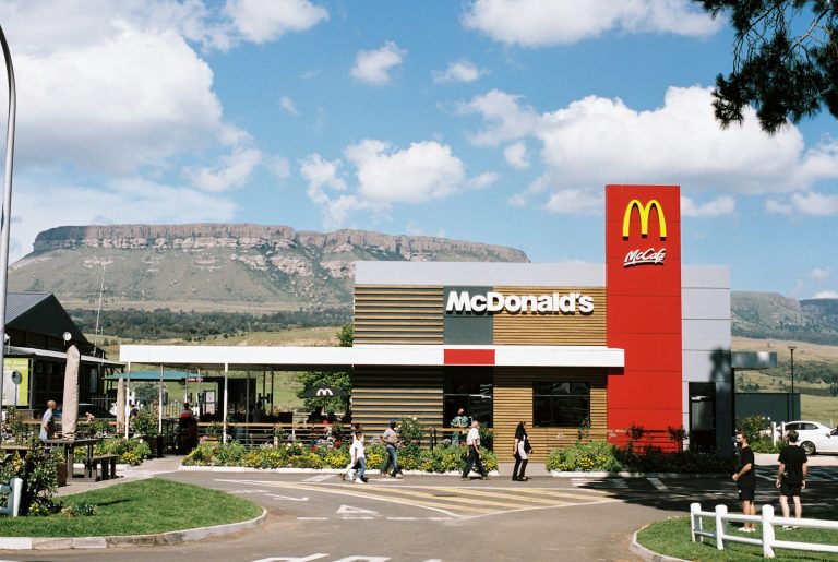 a mcdonald's restaurant with a mountain in the background