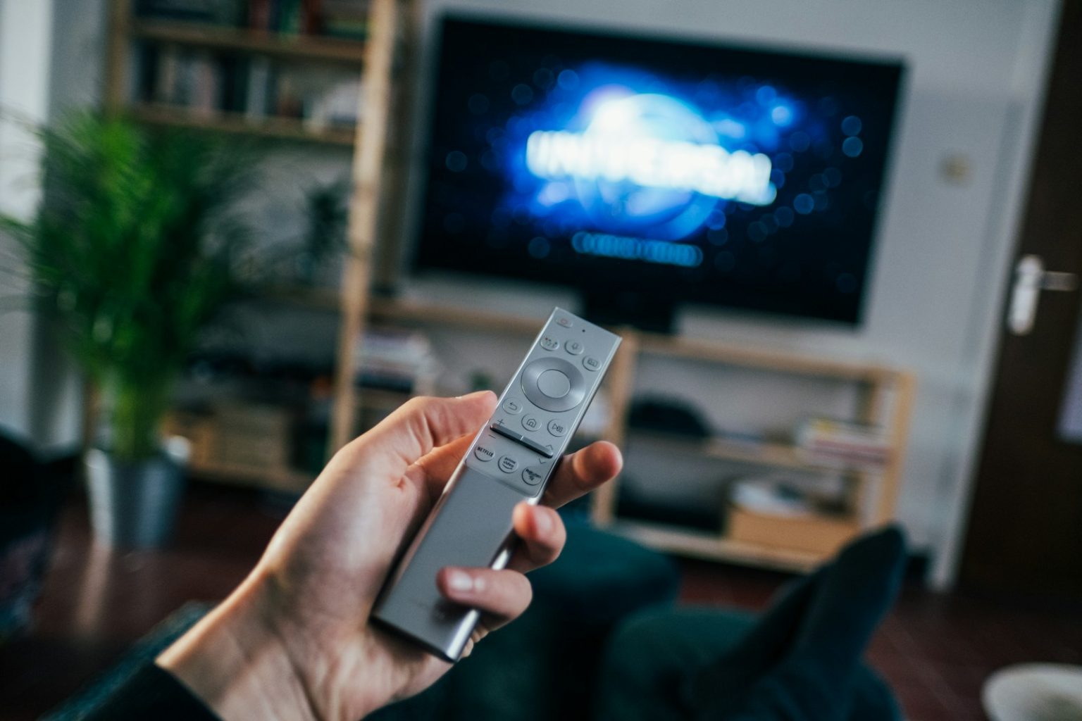 Ile kosztuje reklama w TV? Czynniki wpływające na ceny i strategie oszczędzania person holding gray remote control
