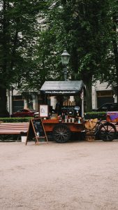 brown wooden carriage in front of brown wooden house during daytime