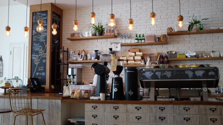 Czy własna kawiarnia to dobry biznes? Wady i zalety prowadzenia kawiarni black kitchen appliance on kitchen island with pendant lights